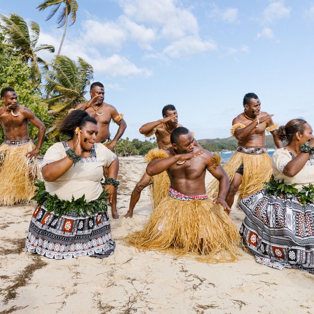 Cultural performance on a Fijian beach — TIL Our Mission